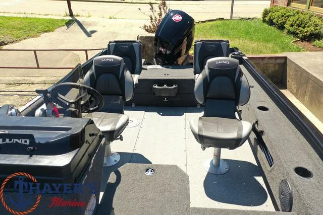 Slide: The Image of 2025 Lund 1775 Adventure SS fishing boat interior with four seats and steering console. - 32