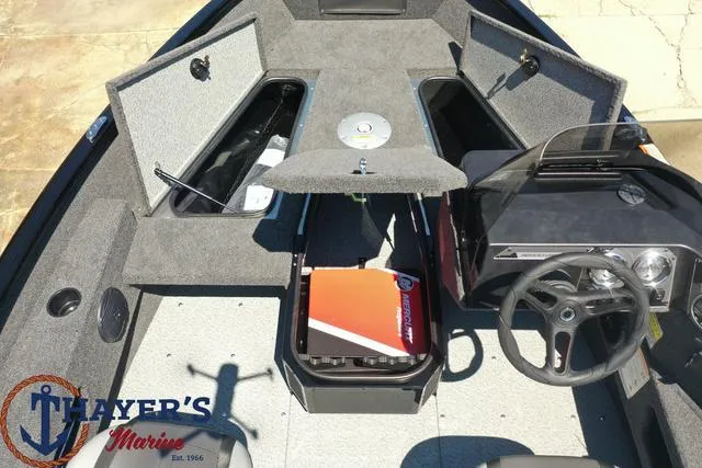 Slide: The Image of 2025 Lund 1775 Adventure SS boat interior with storage compartments and steering console. - 35