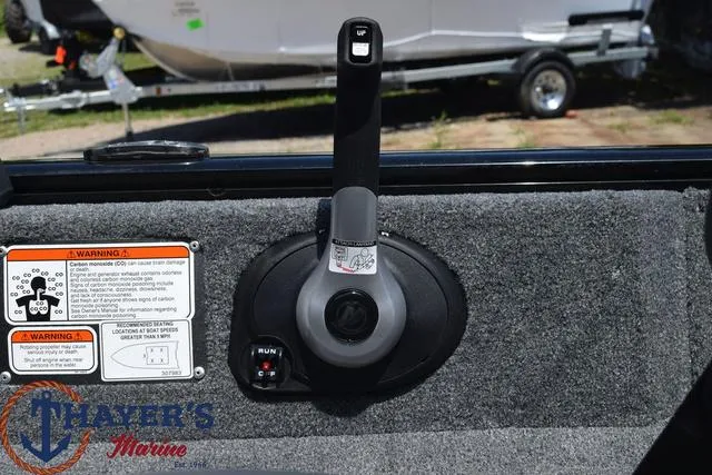 Slide: The Image of 2024 Tracker Pro Guide™ V-16 WT boat control panel with warning labels and throttle. - 12
