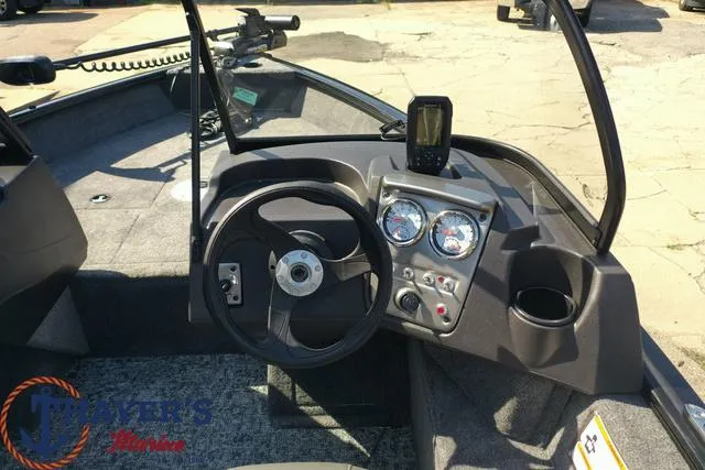 Slide: The Image of 2024 Tracker Pro Guide™ V-16 WT boat dashboard with steering wheel and gauges. - 38