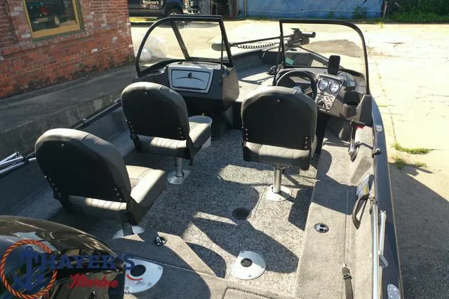 Slide: The Image of 2024 Tracker Pro Guide™ V-16 WT fishing boat interior with three seats and control console. - 39