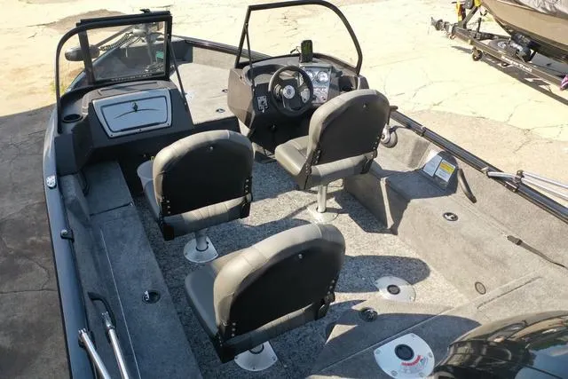 Slide: The Image of 2024 Tracker Pro Guide™ V-16 WT boat interior with seating and steering console. - 42