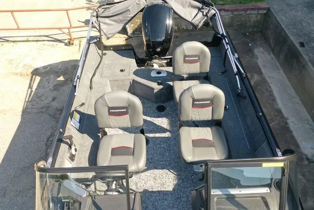 Slide: The Image of 2024 Tracker Pro Guide™ V-16 WT boat interior with four seats and motor. - 44