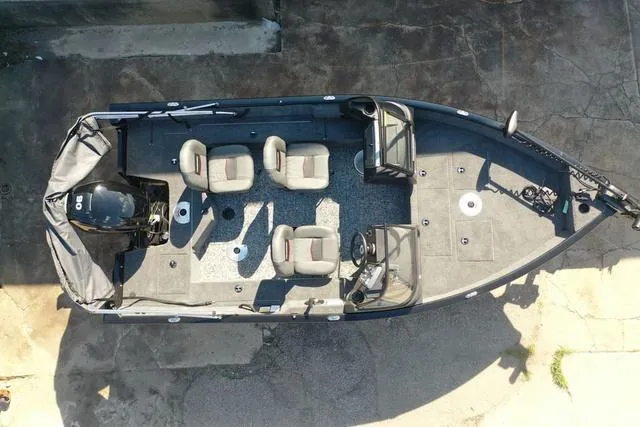 Slide: The Image of 2024 Tracker Pro Guide™ V-16 WT fishing boat, top view, four seats, motor, and steering console. - 45