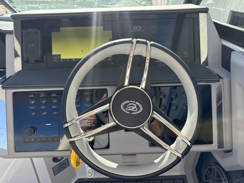 Slide: The Image of Steering wheel and dashboard of 2023 Cobalt R33 boat, featuring modern controls and displays. - 19
