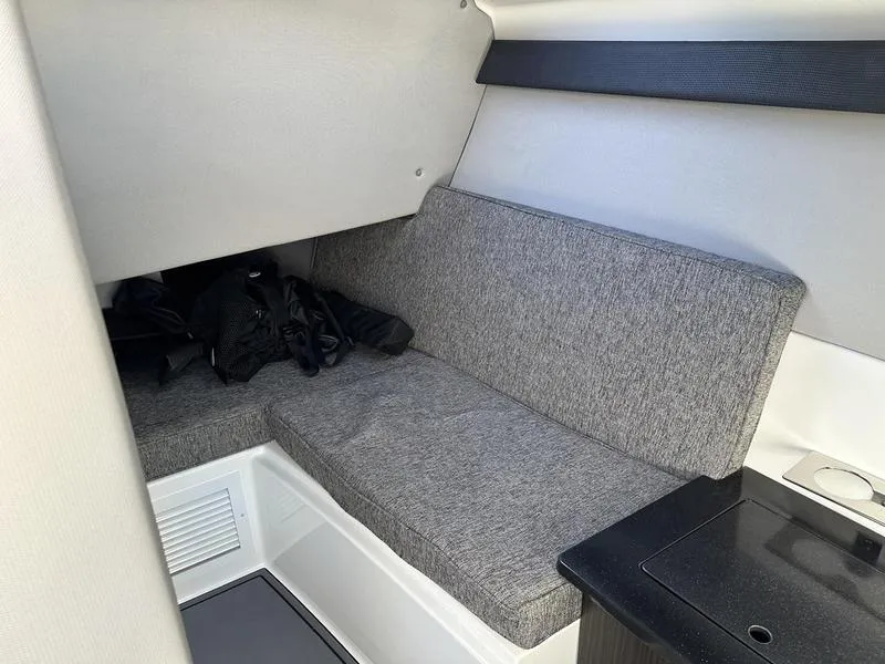 Slide: The Image of Interior cabin of 2023 Cobalt R33 boat with gray seating and storage area. - 21