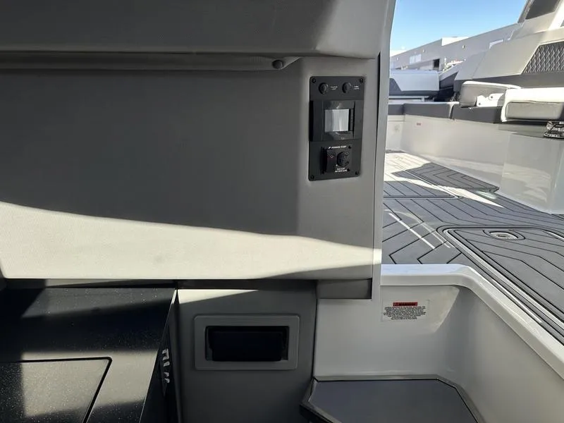 Slide: The Image of Interior view of 2023 Cobalt R33 boat, featuring modern design and control panel. - 23