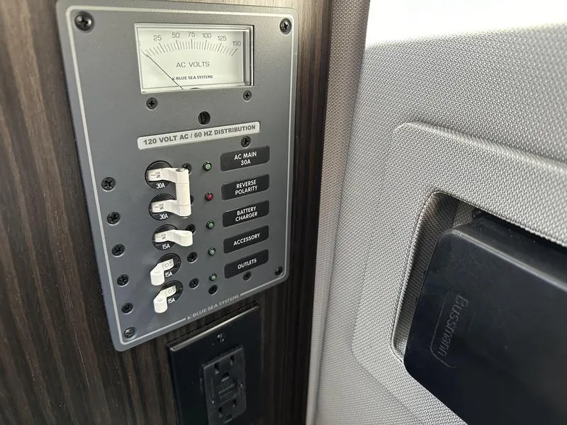 Slide: The Image of Control panel in 2023 Cobalt R33 with AC voltage distribution and switches. - 25