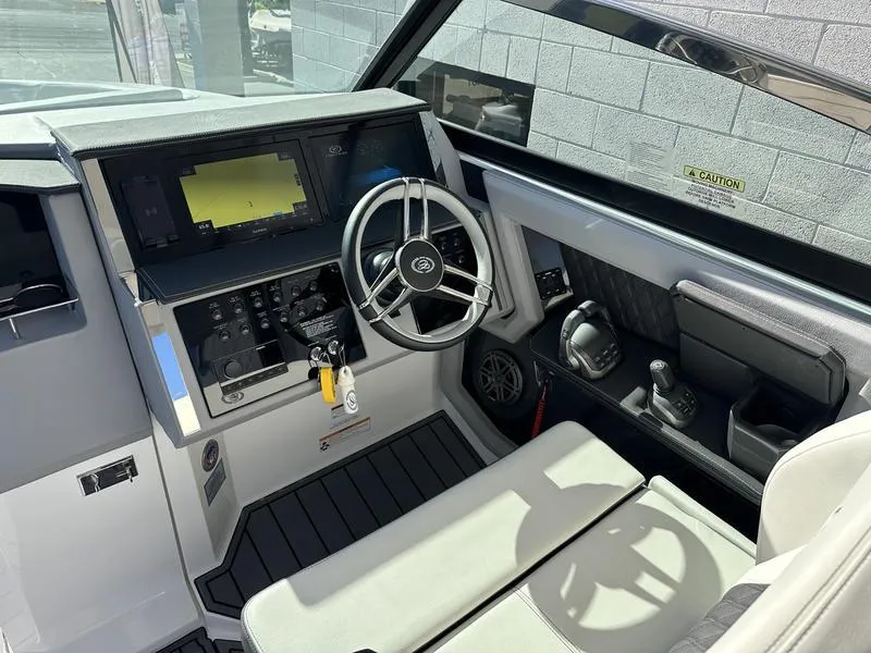 Slide: The Image of 2023 Cobalt R33 boat cockpit with modern steering wheel and navigation system. - 26