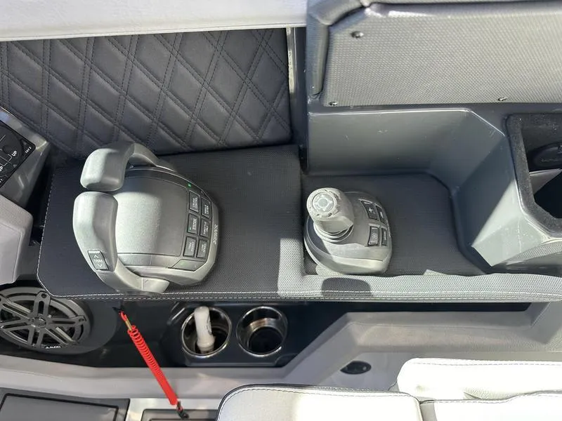 Slide: The Image of Cobalt R33 2023 boat controls with joystick and throttle, featuring modern design and cup holders. - 27