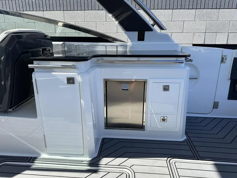 Slide: The Image of 2023 Cobalt R33 boat interior with sleek white cabinetry and modern design. - 28