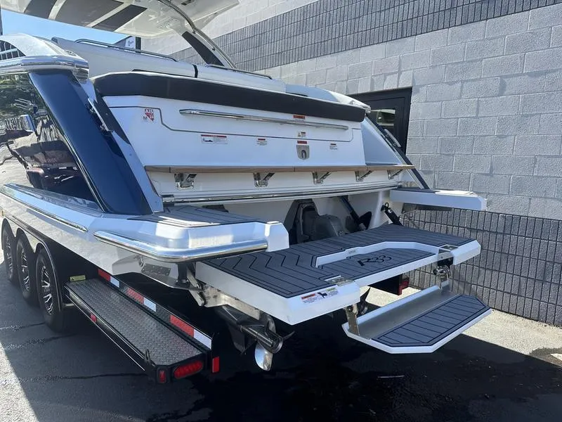 Slide: The Image of 2023 Cobalt R33 boat on trailer, showcasing rear deck and swim platform. - 3
