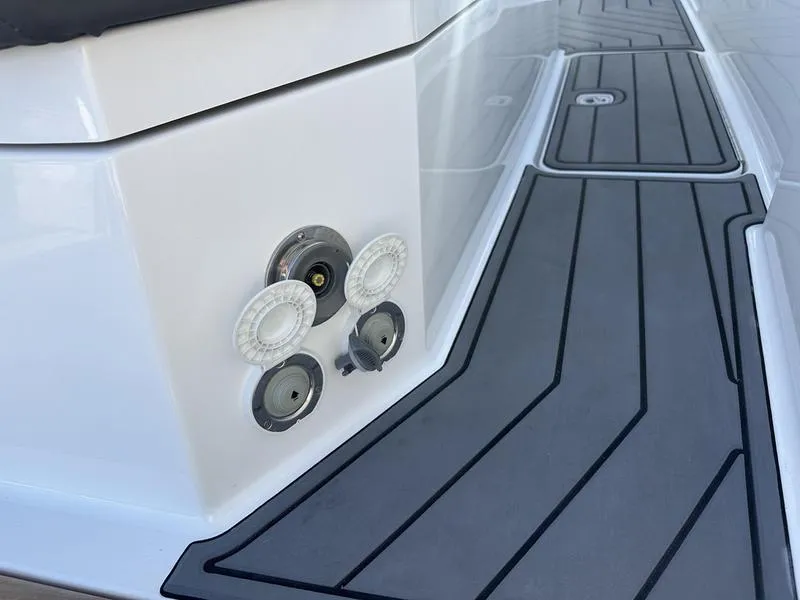Slide: The Image of Cobalt R33 2023 boat deck with sleek gray non-slip surface and utility ports. - 37