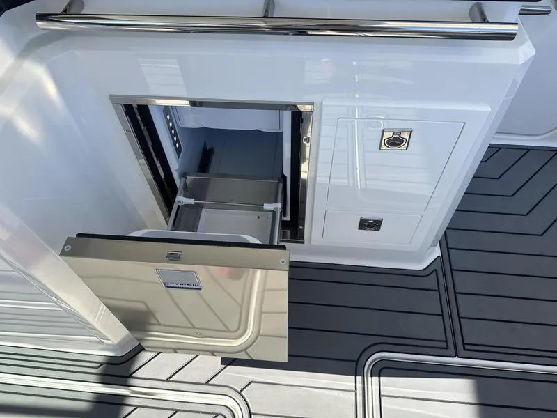 Slide: The Image of 2023 Cobalt R33 boat interior with open storage compartment and sleek flooring. - 48