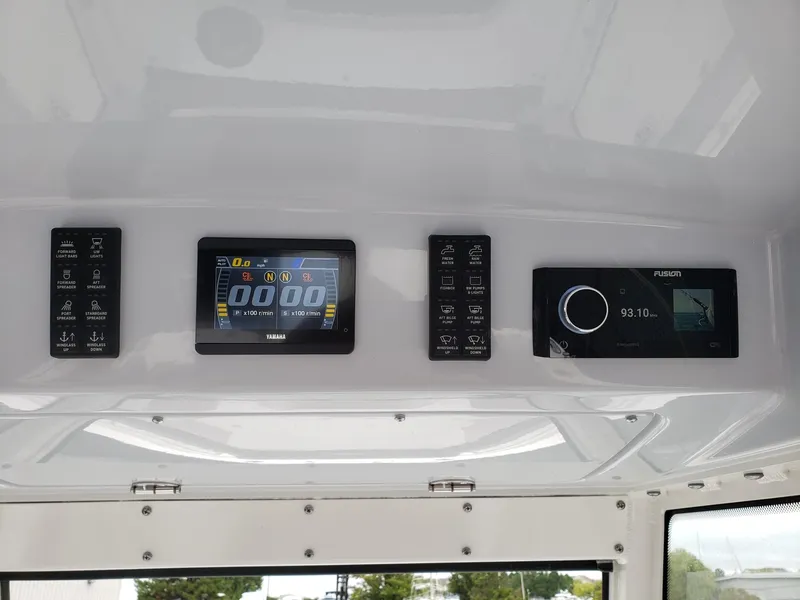 Slide: The Image of Control panel of 2023 Everglades 285CC boat with digital displays and buttons. - 14