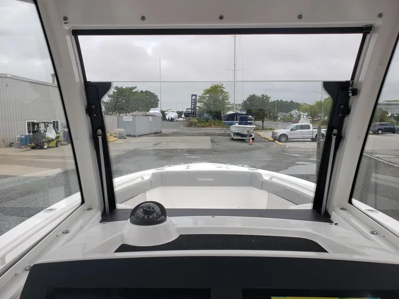 Slide: The Image of Interior view from a 2023 Everglades 285CC boat, showing the dashboard and windshield. - 23