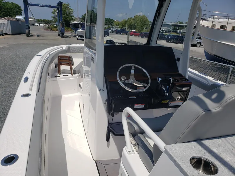 Slide: The Image of 2023 Everglades 285CC boat interior with steering console and seating. - 25