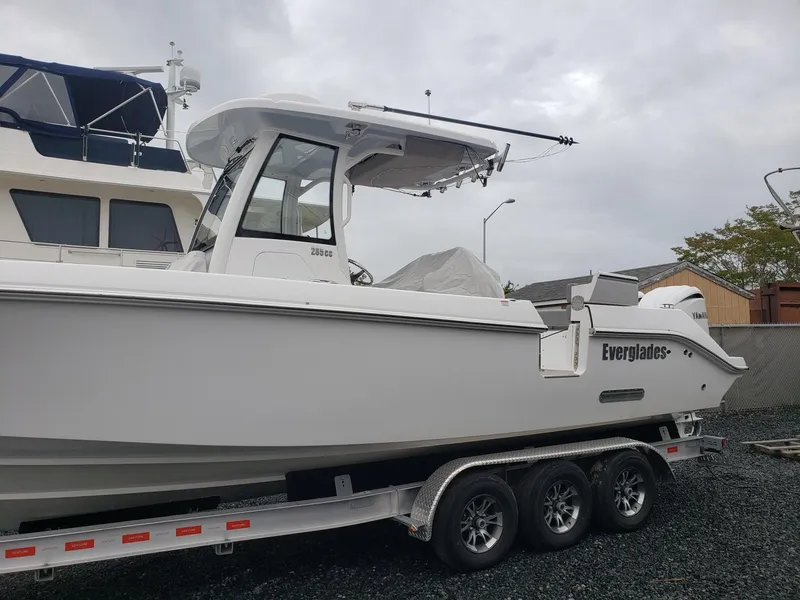 Slide: The Image of 2023 Everglades 285CC boat on a trailer, parked outdoors. - 7