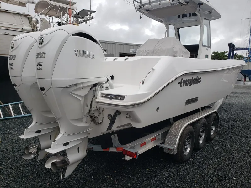 Slide: The Image of 2023 Everglades 285CC boat with twin Yamaha V6 engines on a trailer. - 8