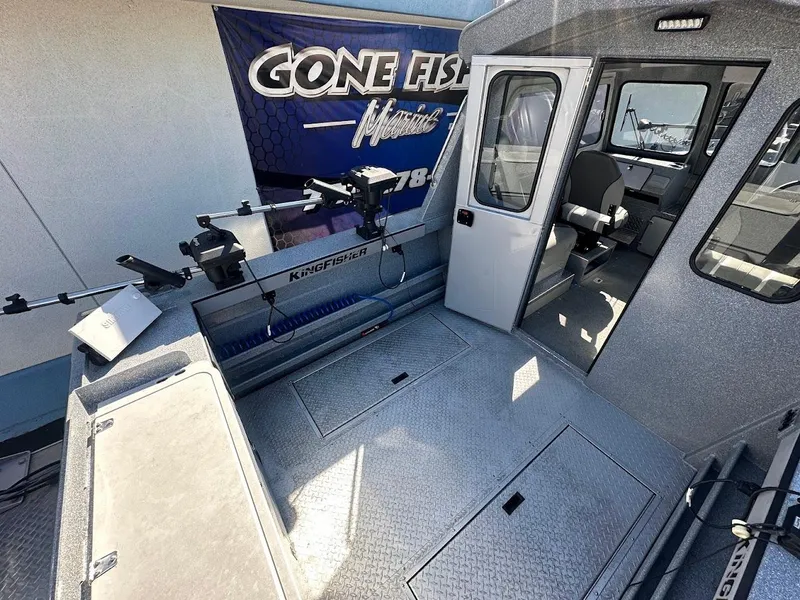 Slide: The Image of 2025 KingFisher 2225 Escape HT boat interior with fishing equipment and seating. - 15