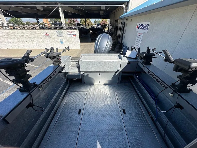 Slide: The Image of 2025 KingFisher 2225 Escape HT boat interior with fishing rod holders. - 16