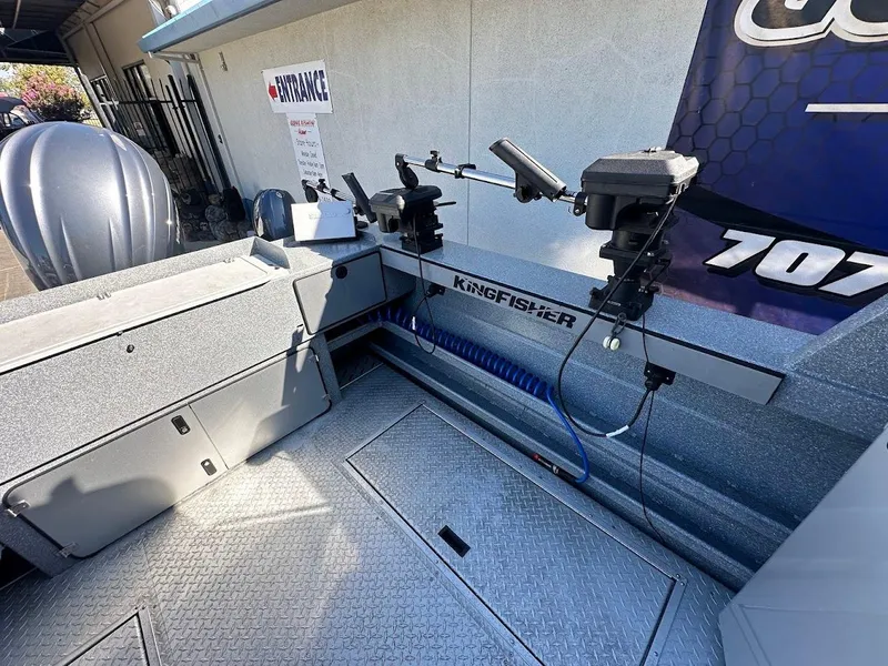 Slide: The Image of 2025 KingFisher 2225 Escape HT boat interior with fishing rod holders and storage compartments. - 18