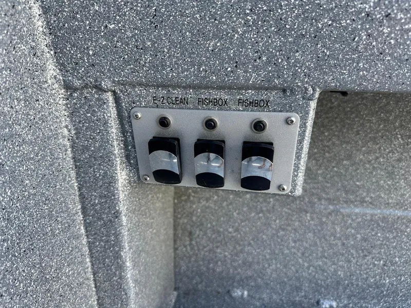 Slide: The Image of Control panel on 2025 KingFisher 2225 Escape HT boat with switches for E-Z Clean and Fishbox. - 28