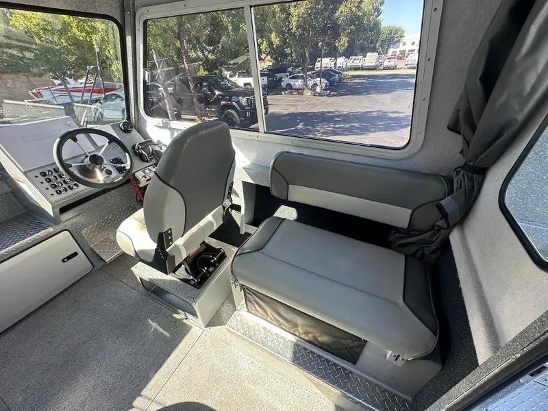 Slide: The Image of Interior of 2025 KingFisher 2225 Escape HT boat, featuring steering wheel and seating. - 30
