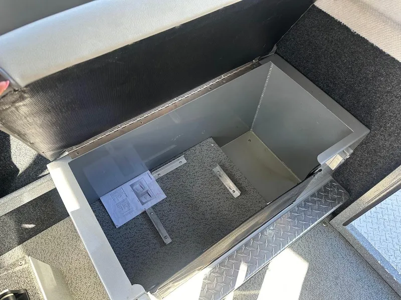 Slide: The Image of Storage compartment in 2025 KingFisher 2225 Escape HT boat, featuring diamond plate flooring. - 31