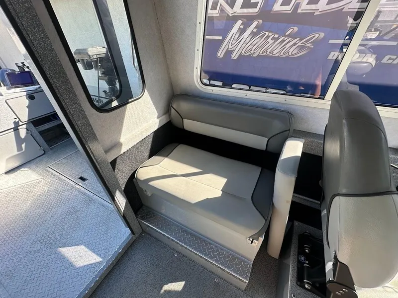 Slide: The Image of Interior of 2025 KingFisher 2225 Escape HT boat, featuring seating and window view. - 32