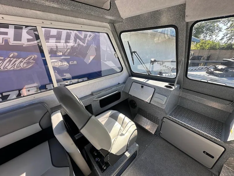 Slide: The Image of Interior of 2025 KingFisher 2225 Escape HT boat, featuring seating and dashboard. - 34