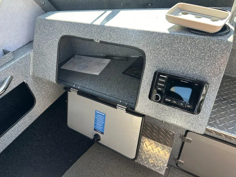 Slide: The Image of Interior of 2025 KingFisher 2225 Escape HT boat with storage compartment and audio system. - 35