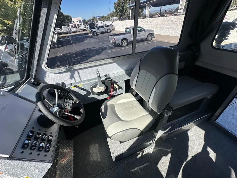 Slide: The Image of Interior of 2025 KingFisher 2225 Escape HT boat, featuring steering wheel and control panel. - 39