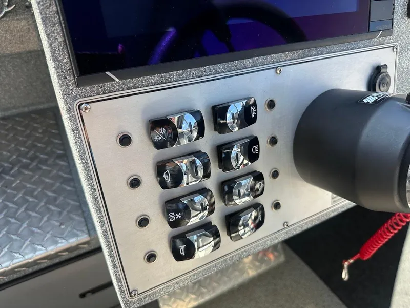 Slide: The Image of Control panel of 2025 KingFisher 2225 Escape HT boat with switches and steering wheel. - 42