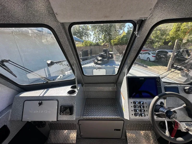 Slide: The Image of Interior view of 2025 KingFisher 2225 Escape HT boat cockpit with steering and control panel. - 45
