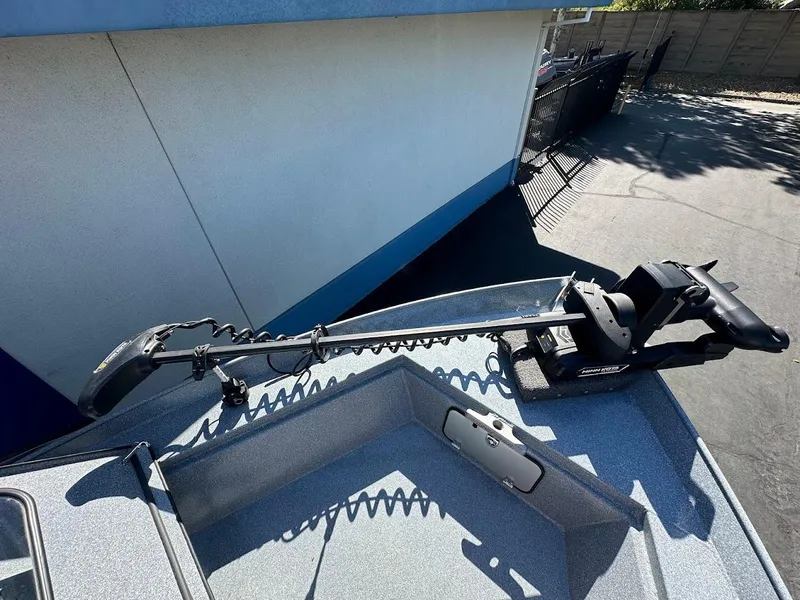 Slide: The Image of 2025 KingFisher 2225 Escape HT boat with mounted trolling motor on deck. - 48