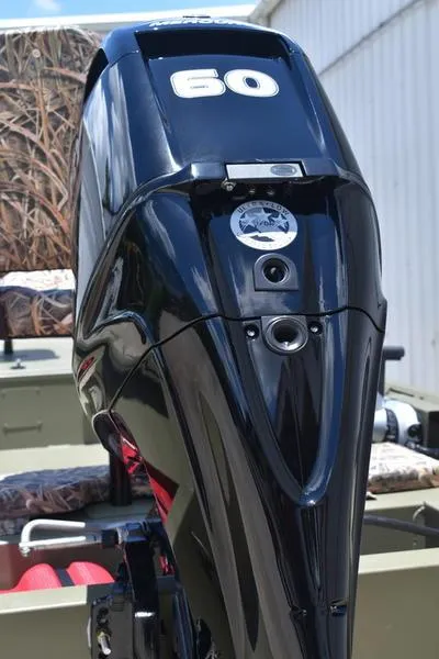 Slide: The Image of 2025 Lowe RX1860 RAMBLER boat engine, black with "60" marking, outdoors. - 18