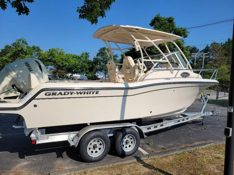 Slide: The Image of 2025 Grady-White Adventure 218 boat on trailer, parked outdoors. - 4