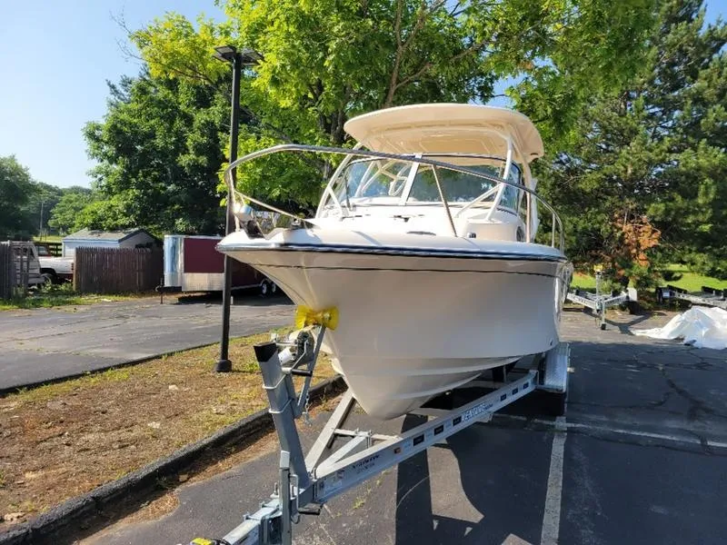 Slide: The Image of 2025 Grady-White Adventure 218 boat on trailer, parked outdoors. - 5