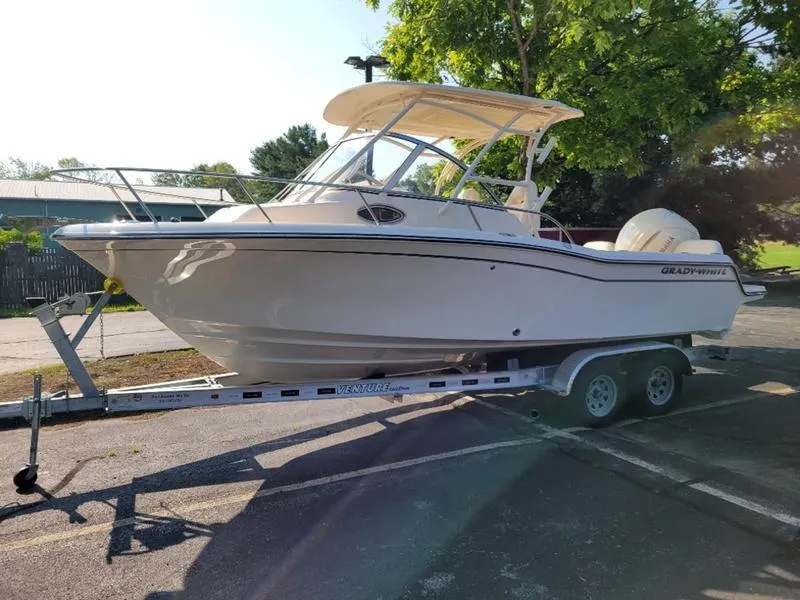 Slide: The Image of 2025 Grady-White Adventure 218 boat on trailer, parked outdoors. - 7