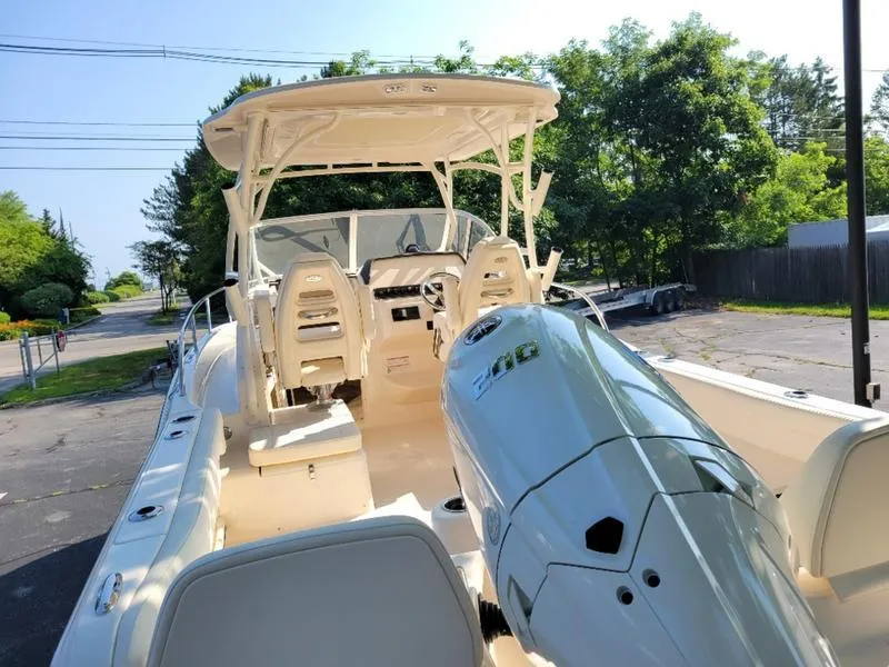 Slide: The Image of 2025 Grady-White Adventure 218 boat with powerful engine, parked outdoors. - 8