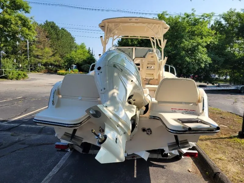 Slide: The Image of 2025 Grady-White Adventure 218 boat with outboard motor in a parking lot. - 9