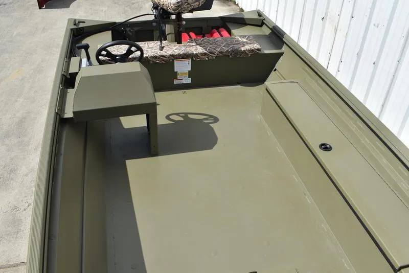 Slide: The Image of 2025 Lowe RX1860 RAMBLER boat interior with steering wheel and camouflage seating. - 14