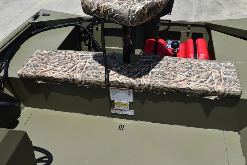 Slide: The Image of 2025 Lowe RX1860 RAMBLER boat interior with camouflage seating and storage compartments. - 18