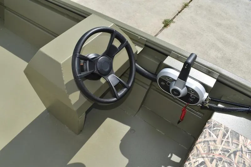 Slide: The Image of Steering console of 2025 Lowe RX1860 RAMBLER boat, featuring a wheel and control panel. - 20