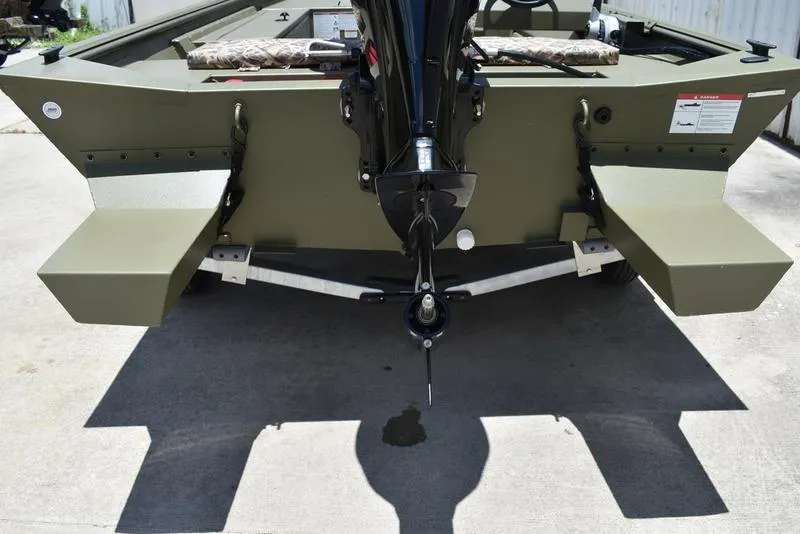 Slide: The Image of 2025 Lowe RX1860 RAMBLER boat, rear view with motor, parked on concrete. - 3