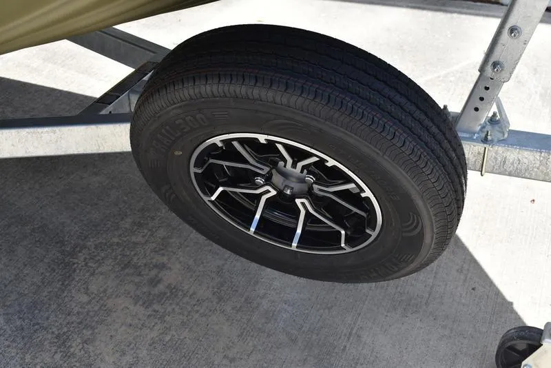 Slide: The Image of Trailer wheel of 2025 Lowe RX1860 RAMBLER on concrete surface. - 9