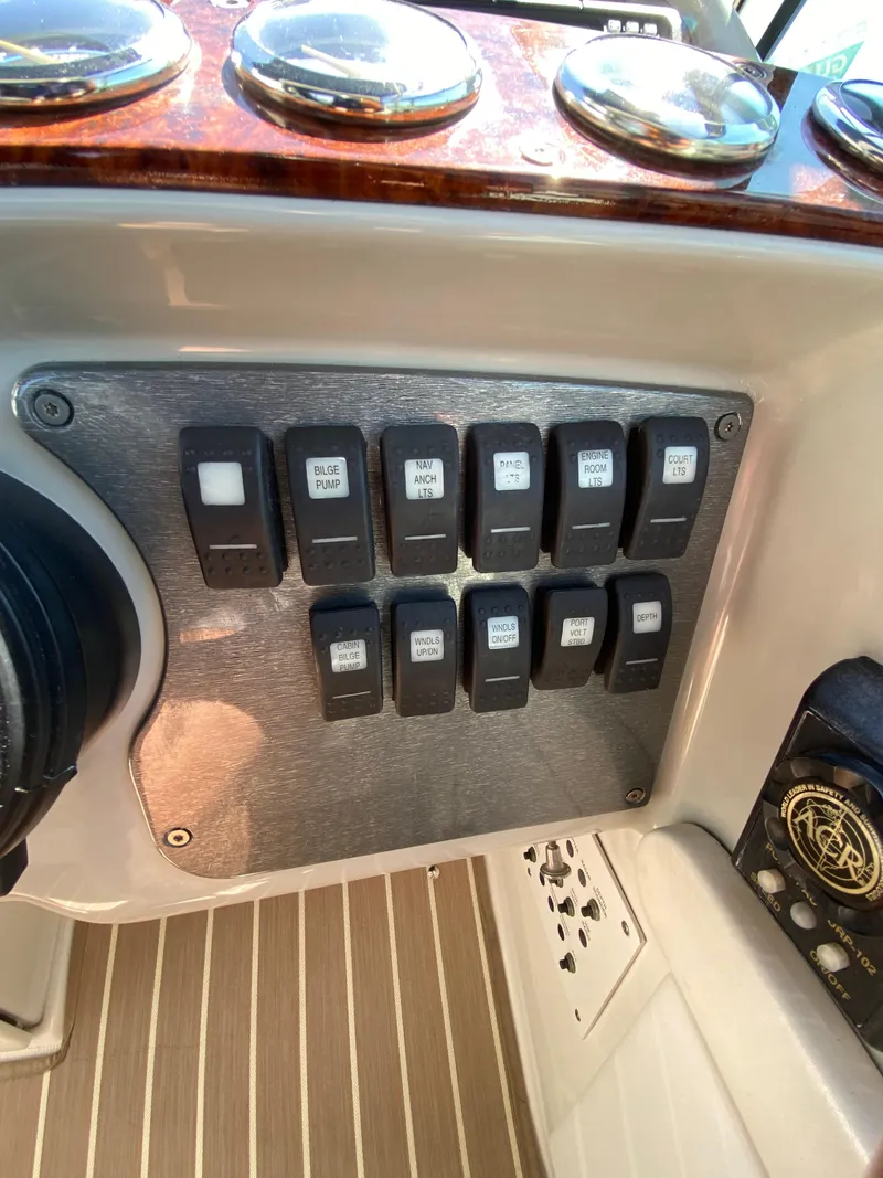 Slide: The Image of Control panel of a 2004 Formula 370 Super Sport boat with labeled switches. - 15