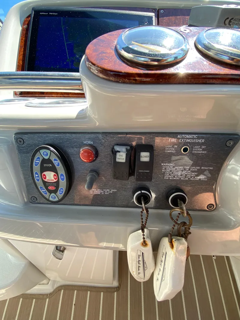 Slide: The Image of Control panel of a 2004 Formula 370 Super Sport boat with keys and switches. - 16