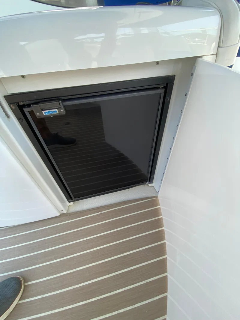 Slide: The Image of 2004 Formula 370 Super Sport boat interior with built-in mini fridge. - 19